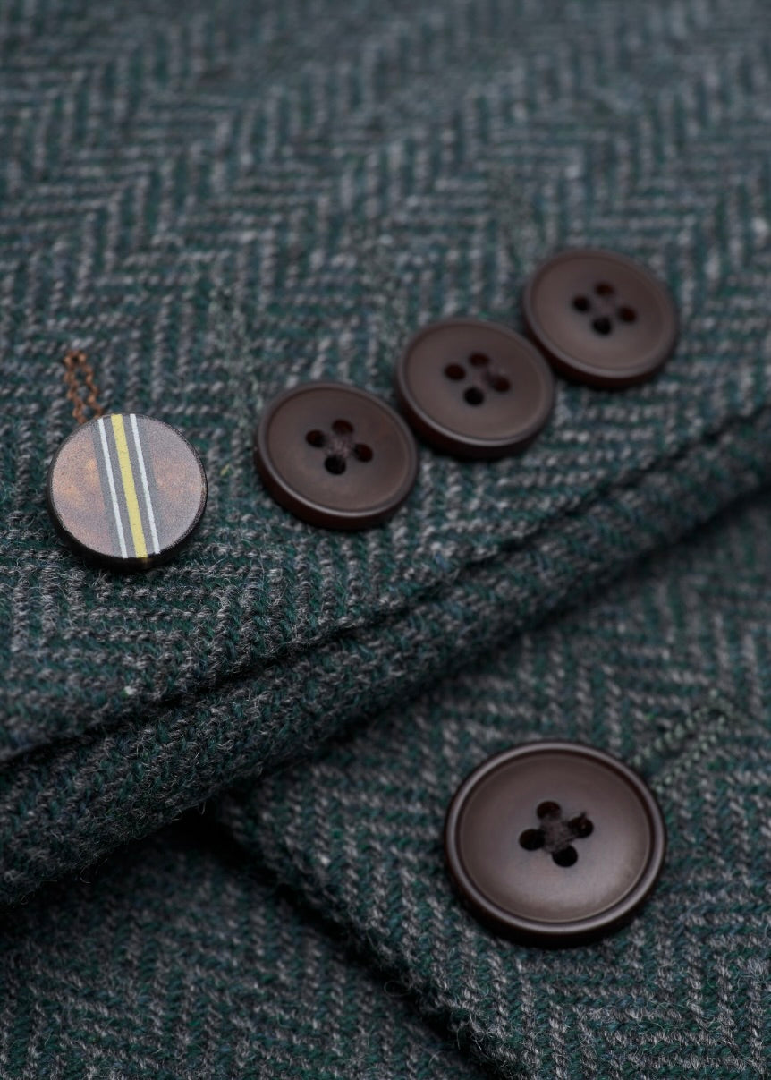 Close-up of dark brown buttons on a textured fabric background